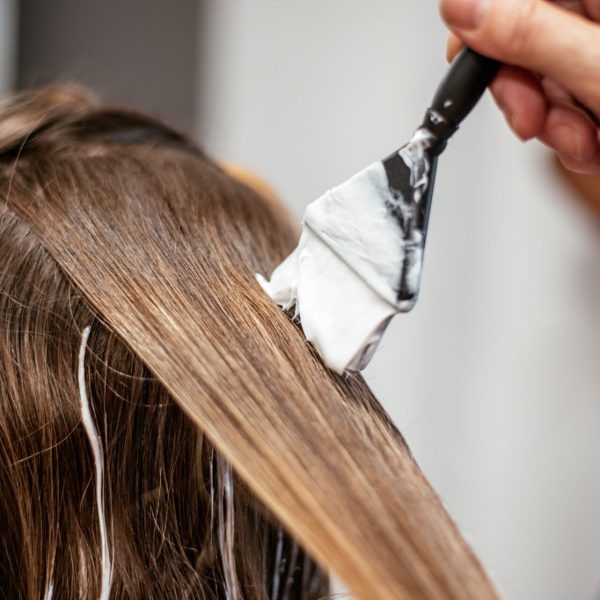 Hairdresser dyeing a woman's hair